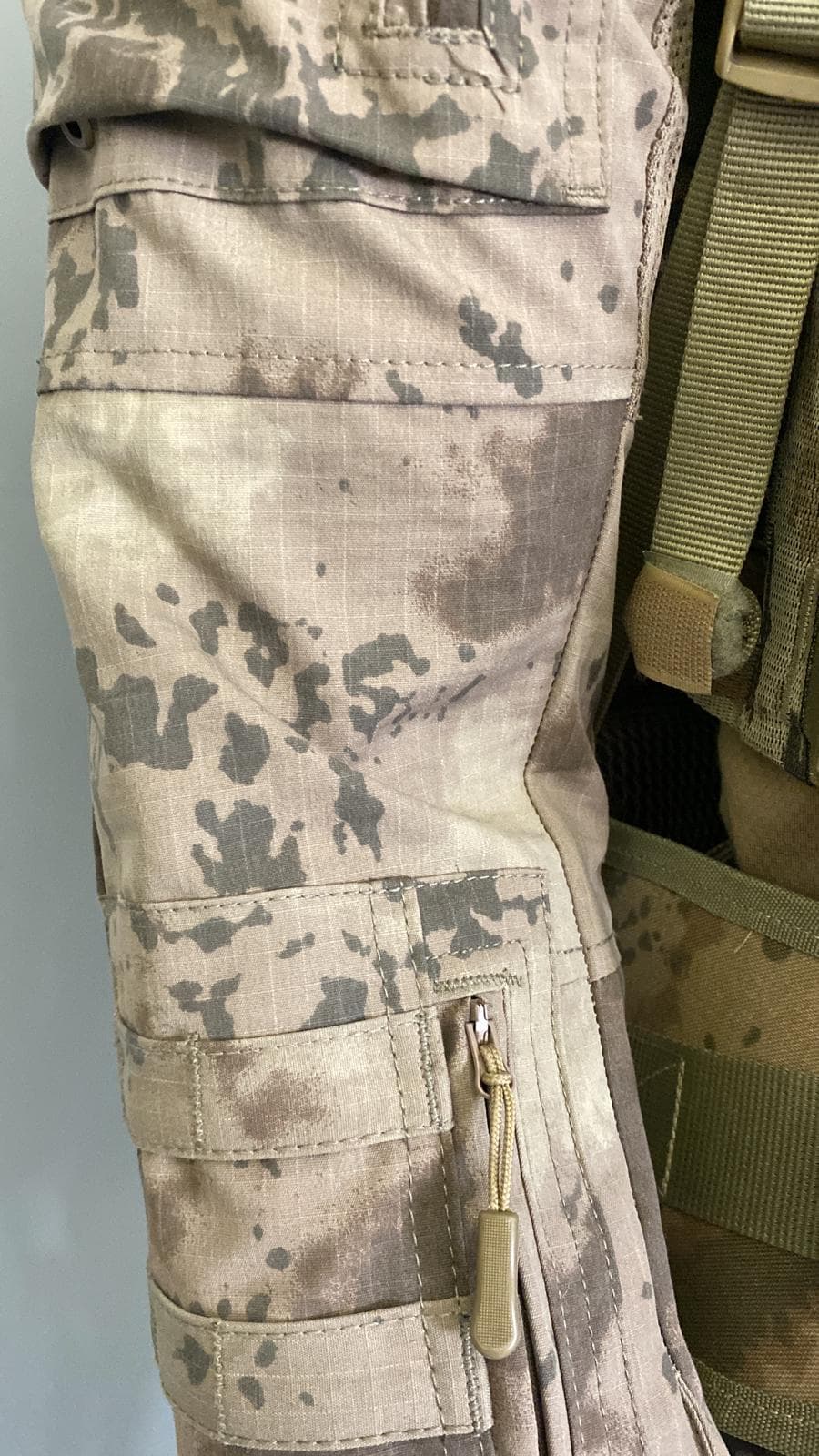 Pocket and fastening detail on a camouflage garment